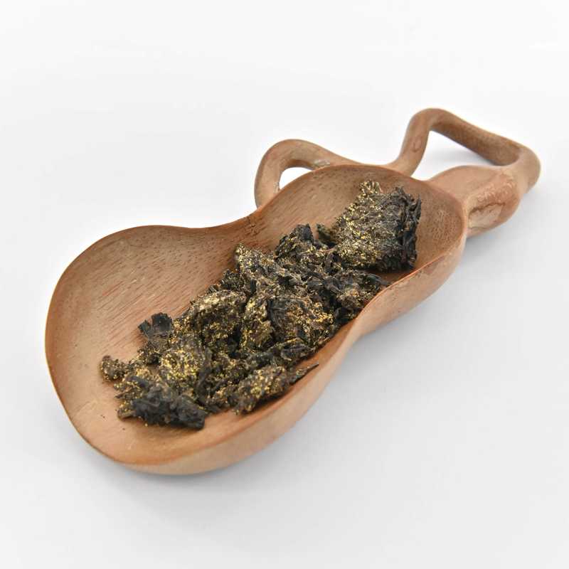 Flower Tea Brick (2019 Gold Medal) in a scoop