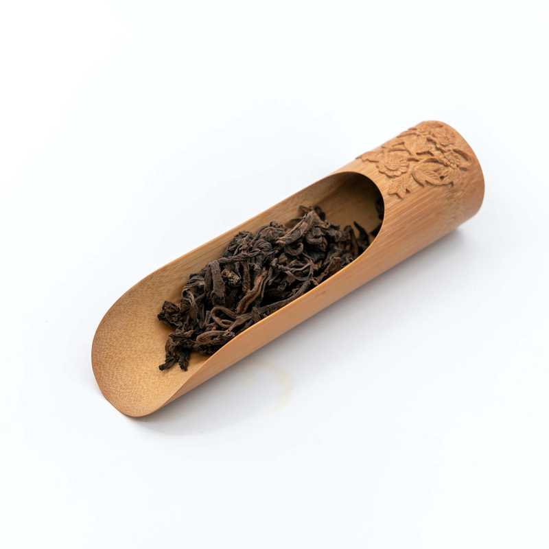 Aged Zhengshan Brown Pu'er in a scoop